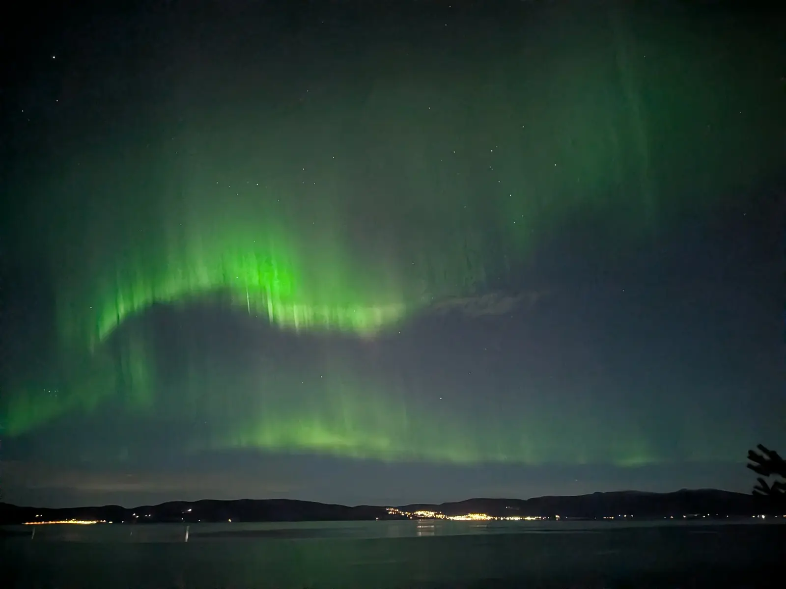 Trondheim city lights reflected across the fjord at night
